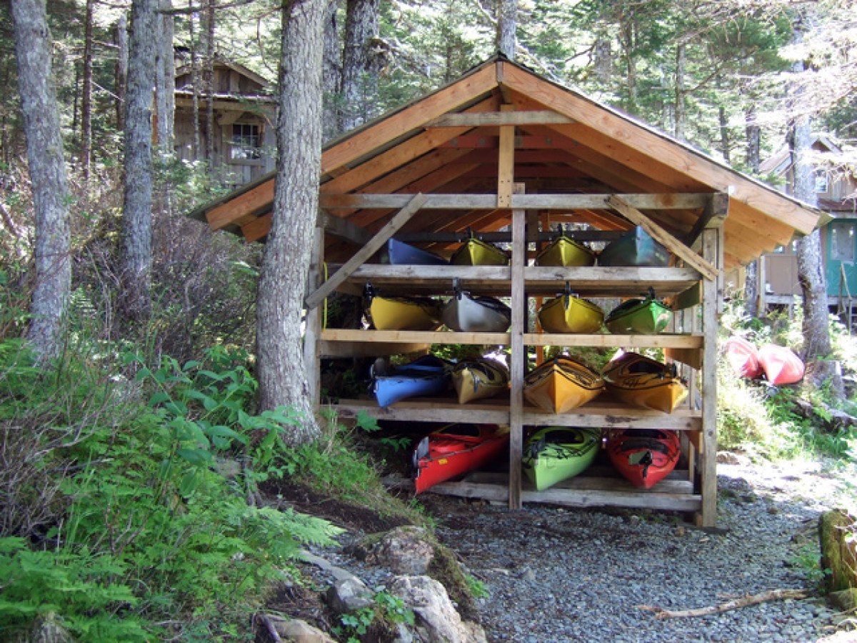 Kayaks lined up in a shed at kayakers cove in Seward, Alaska