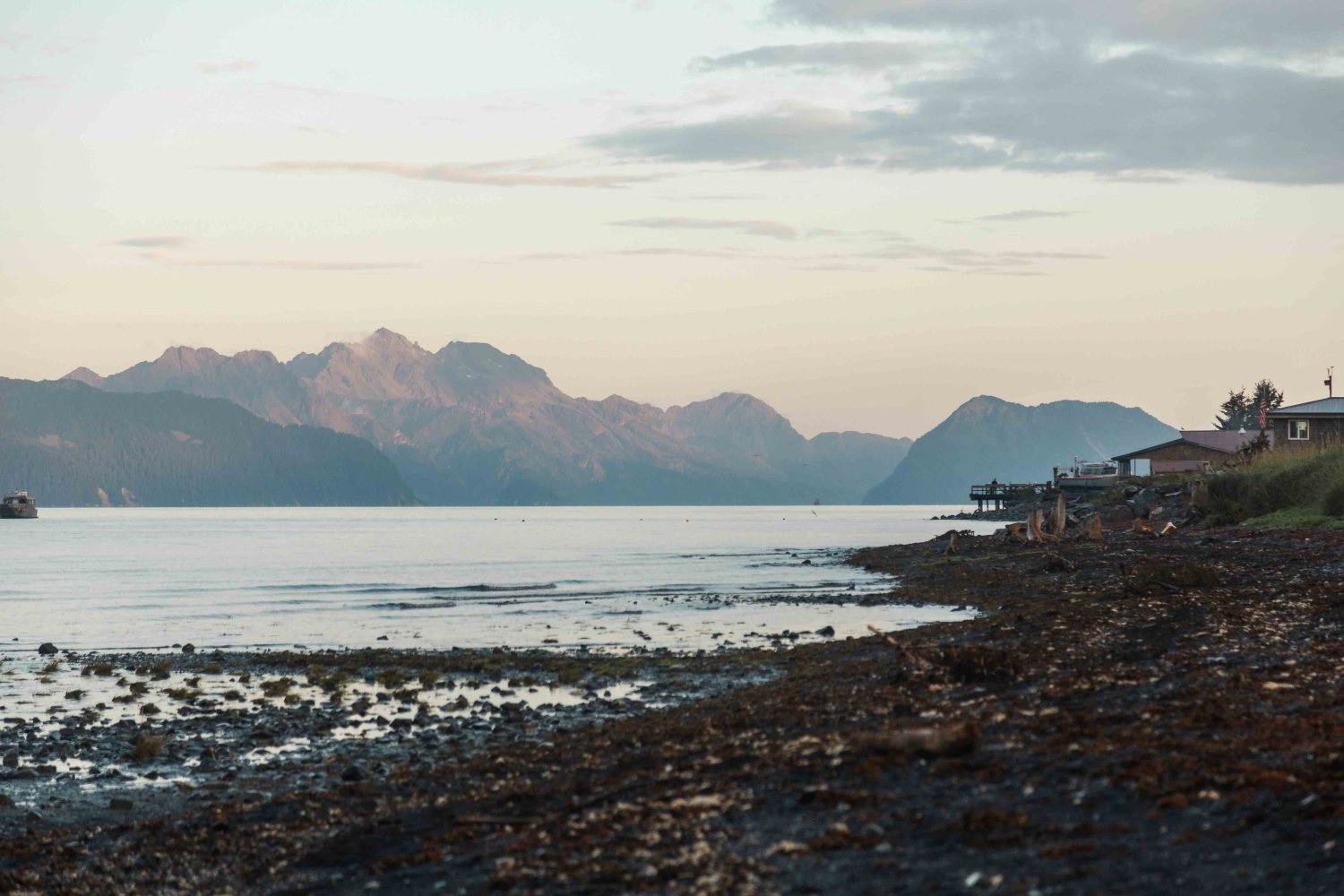 a group of people on a beach near a body of water